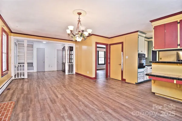 a view of a livingroom with wooden floor and stairs