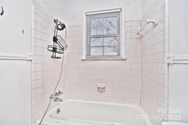 a bathroom with a bathtub and shower
