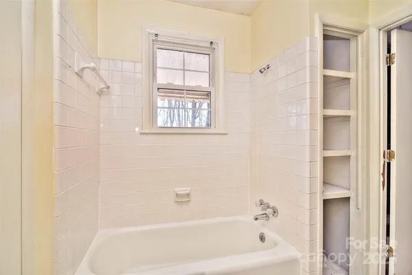 a bathroom with a bathtub and shower