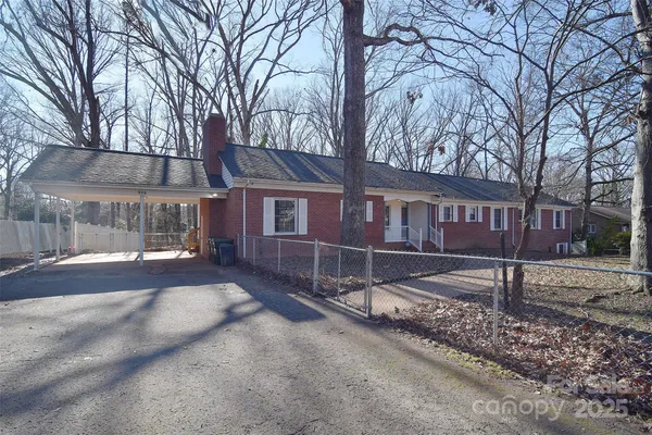 a view of a house with a yard covered in snow