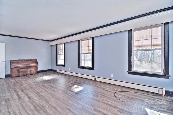 a view of livingroom with furniture hardwood floor and workspace