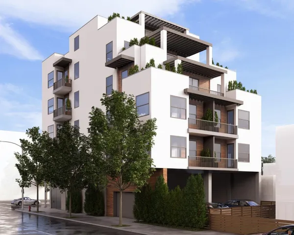 an aerial view of residential houses with trees