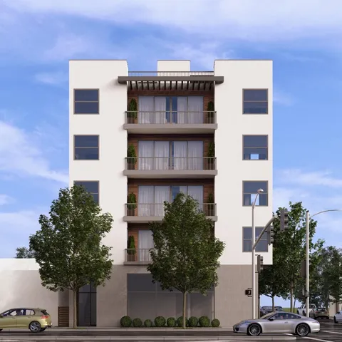 a front view of a building with a garden and plants