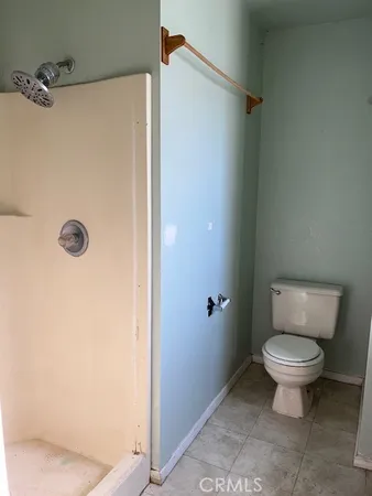 a bathroom with a sink toilet and window