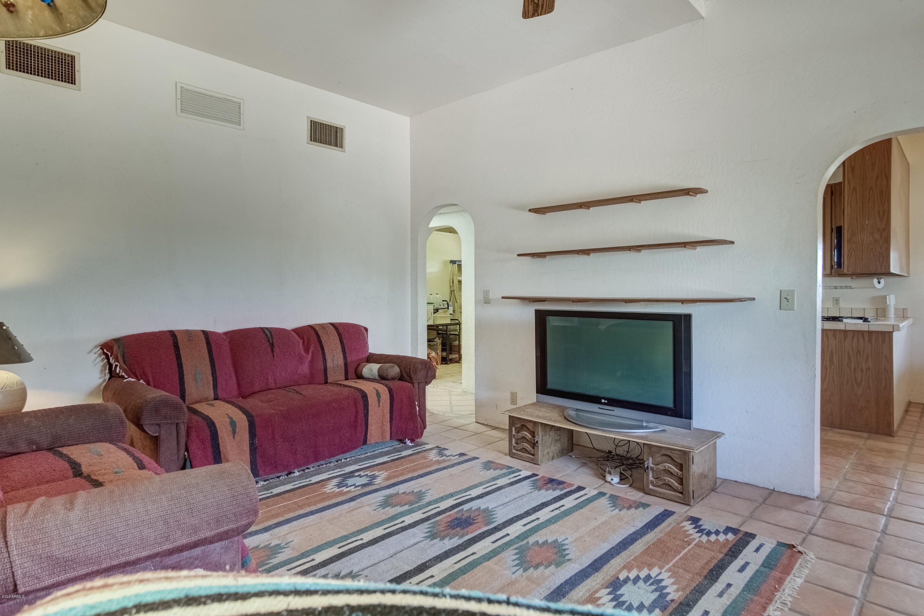667 South Opal Road Maricopa, AZ 85139 - Photo 15 of 42 a living room with a flat screen tv and a rug