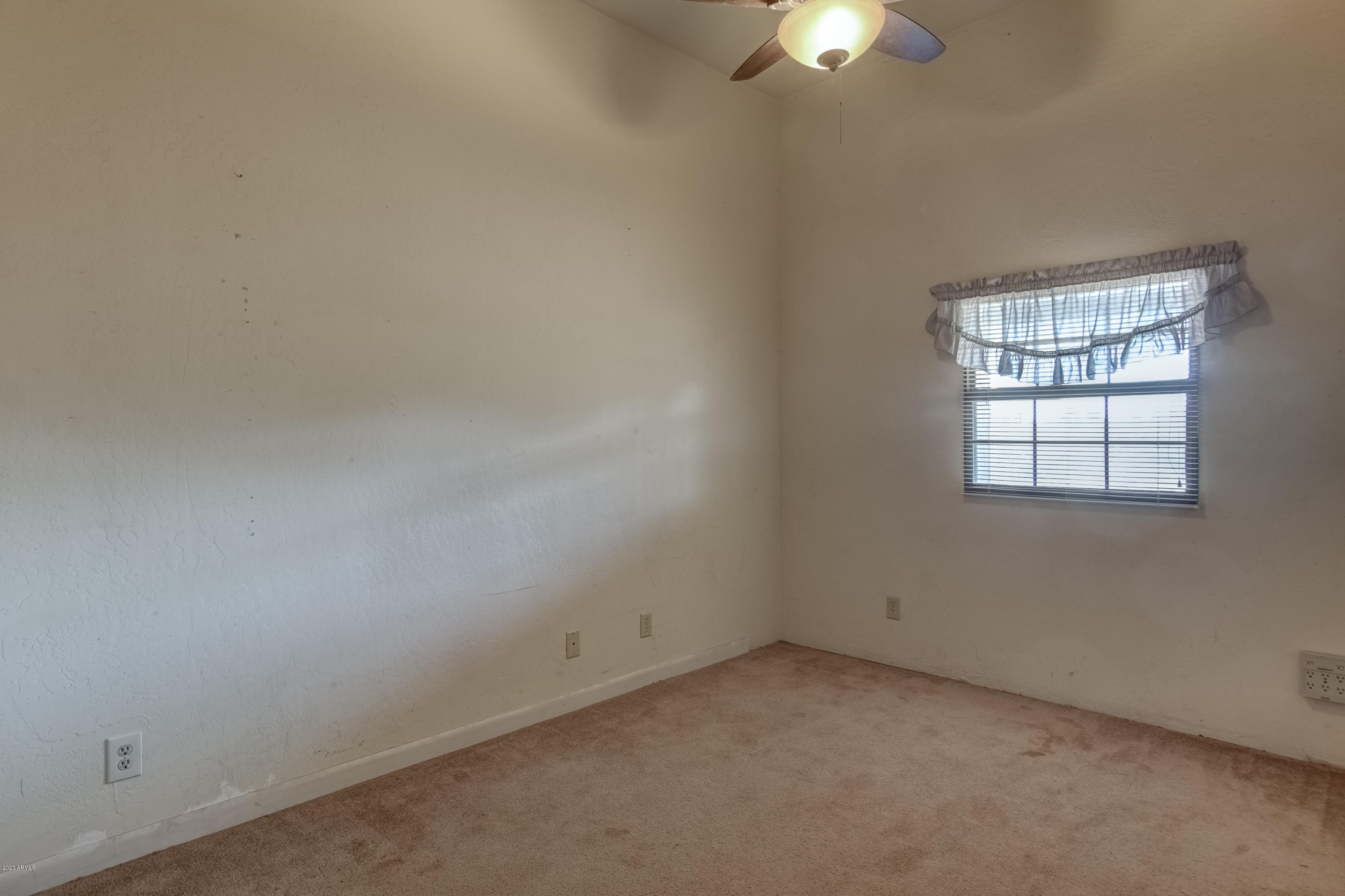 667 South Opal Road Maricopa, AZ 85139 - Photo 19 of 42 an empty room with a fan and a window