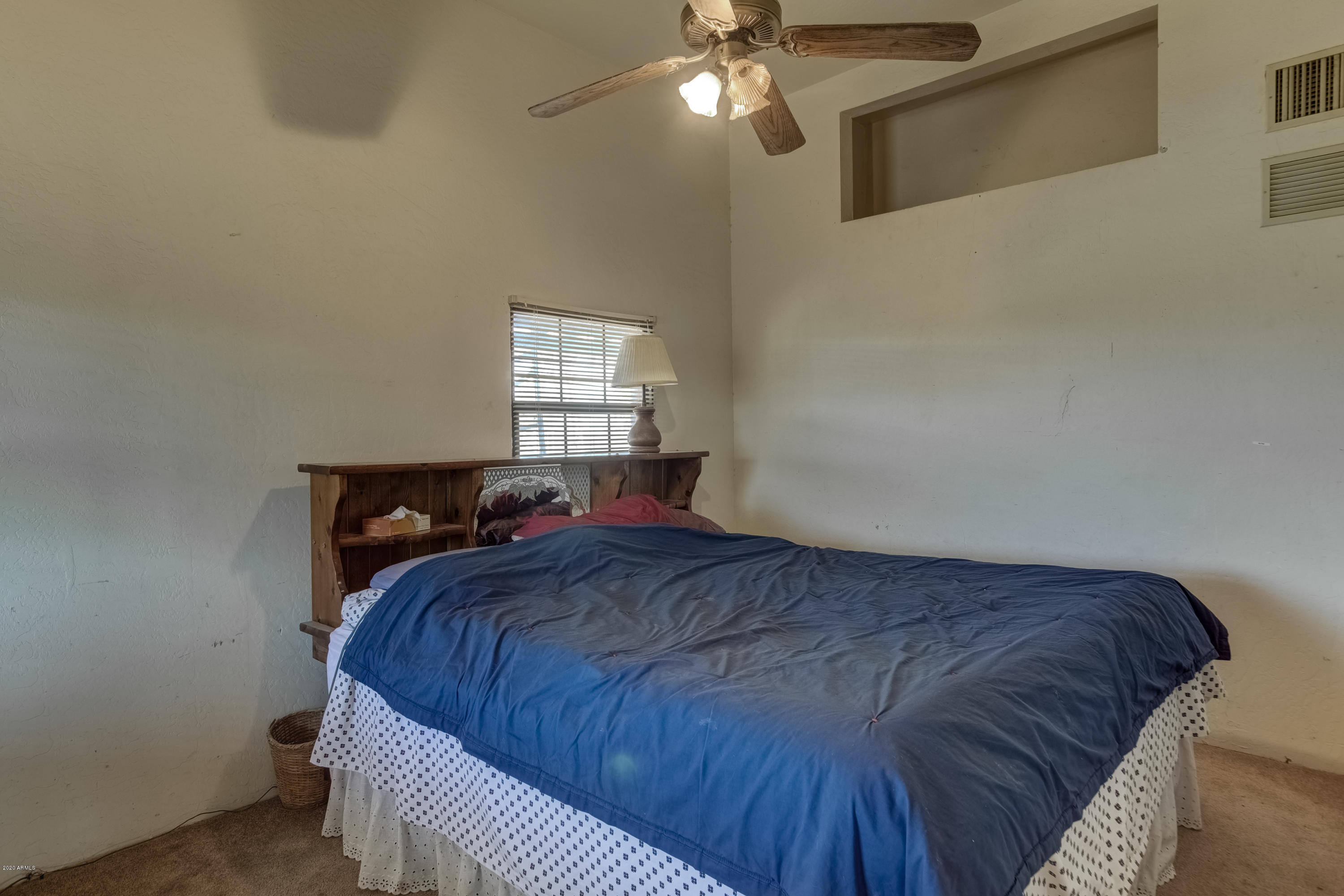 667 South Opal Road Maricopa, AZ 85139 - Photo 26 of 42 a bed sitting in a bedroom next to a window
