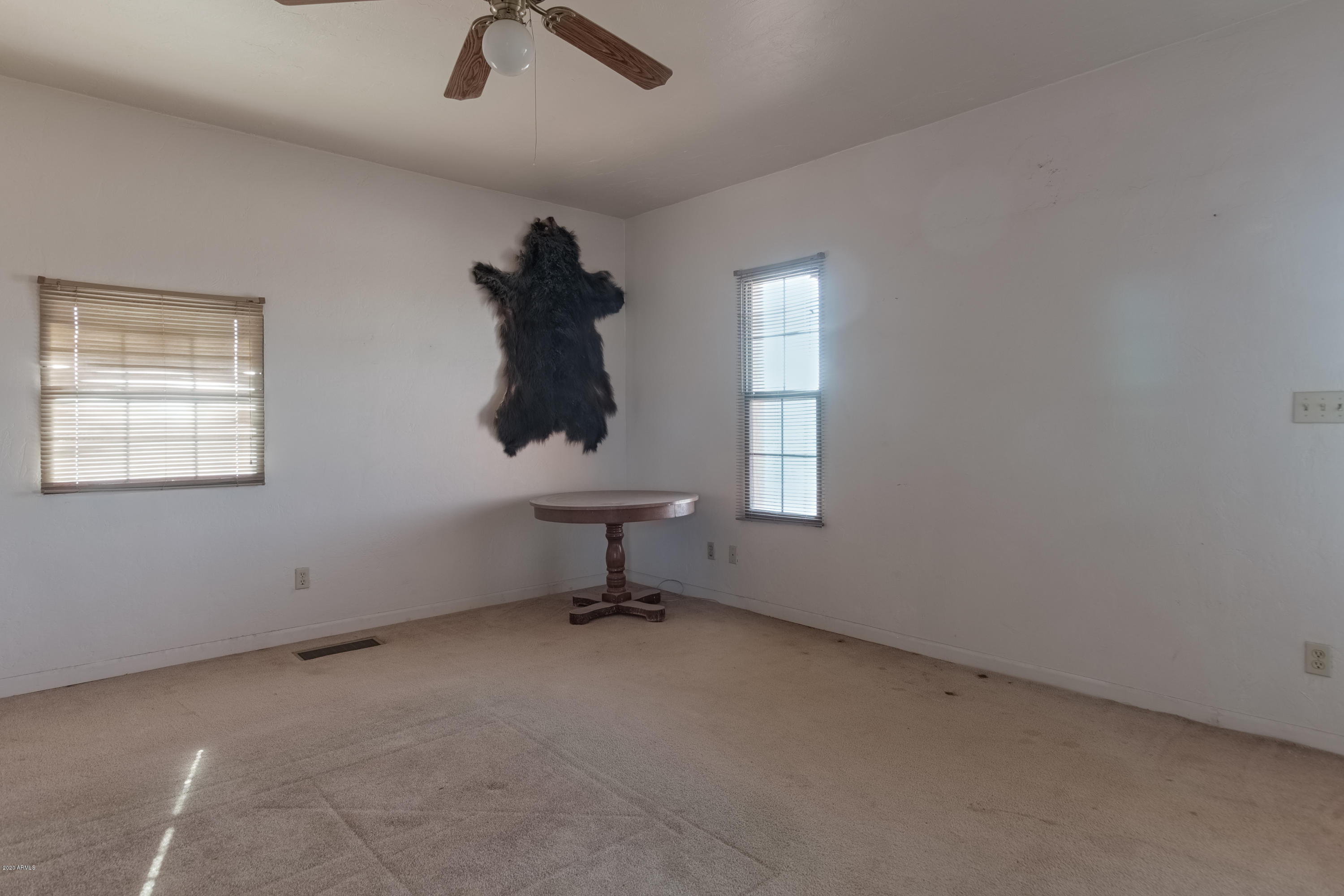 667 South Opal Road Maricopa, AZ 85139 - Photo 31 of 42 an empty room with windows and fan