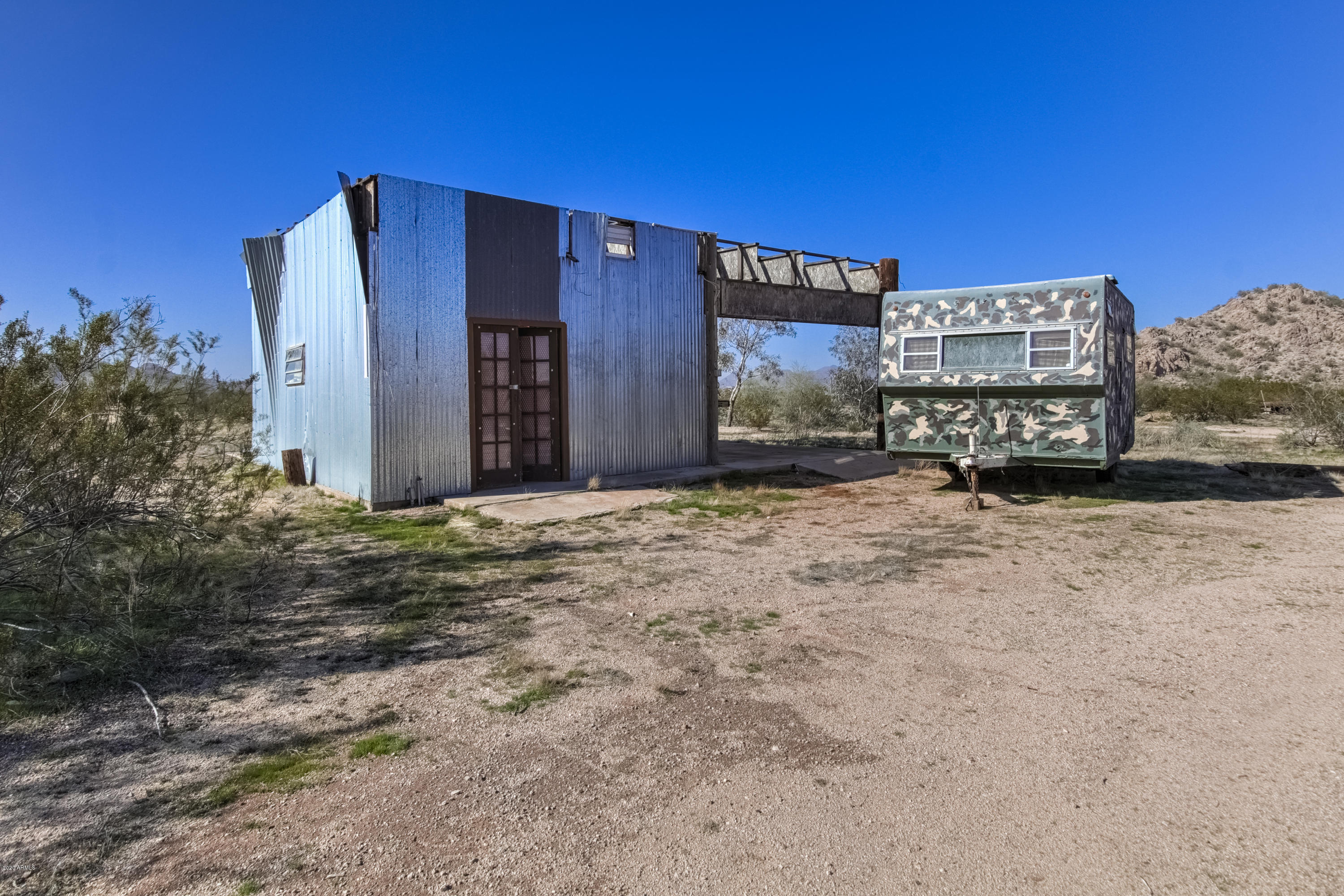 667 South Opal Road Maricopa, AZ 85139 - Photo 33 of 42 a view of a building with a snow in the yard
