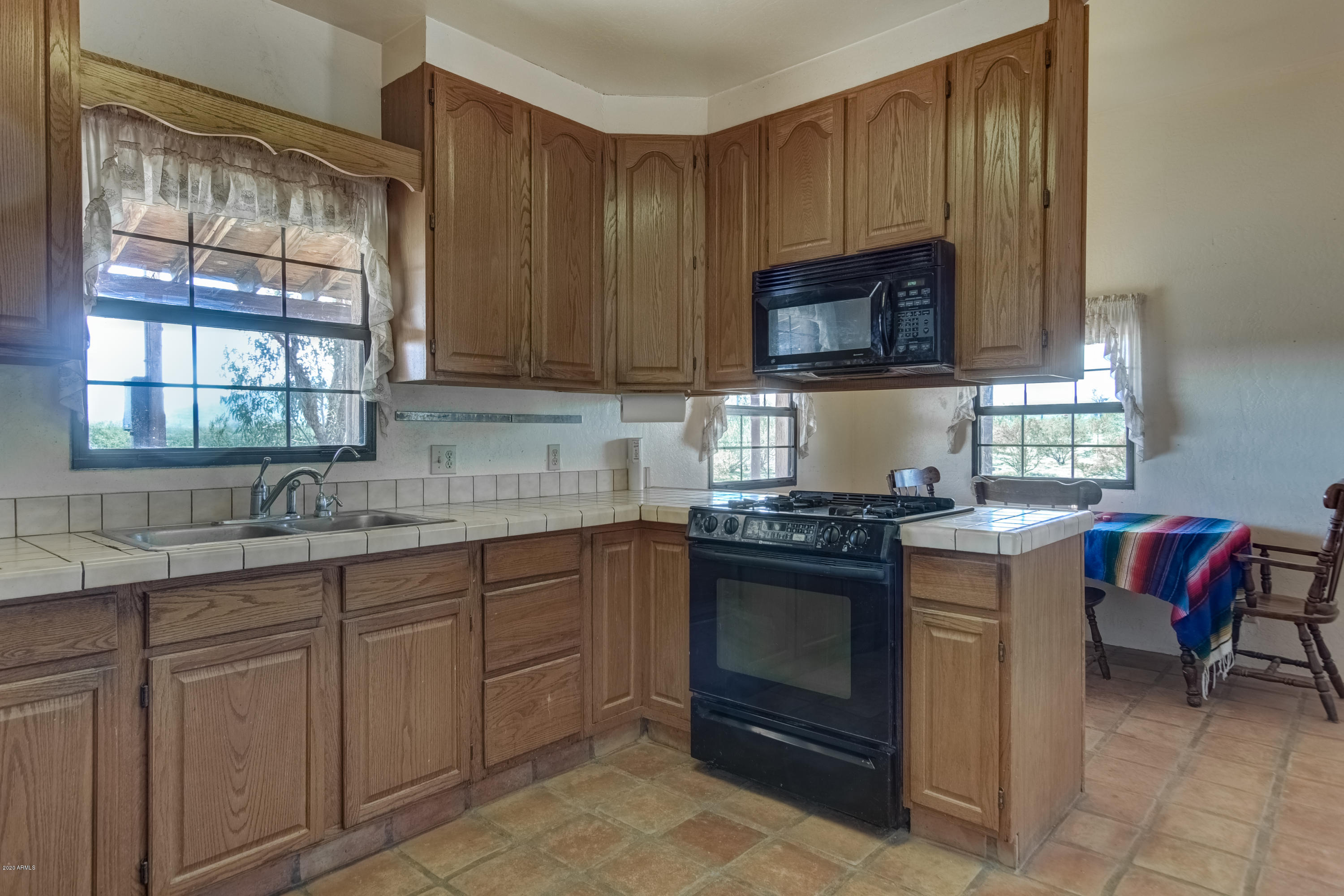 667 South Opal Road Maricopa, AZ 85139 - Photo 4 of 42 a kitchen with cabinets appliances and a window