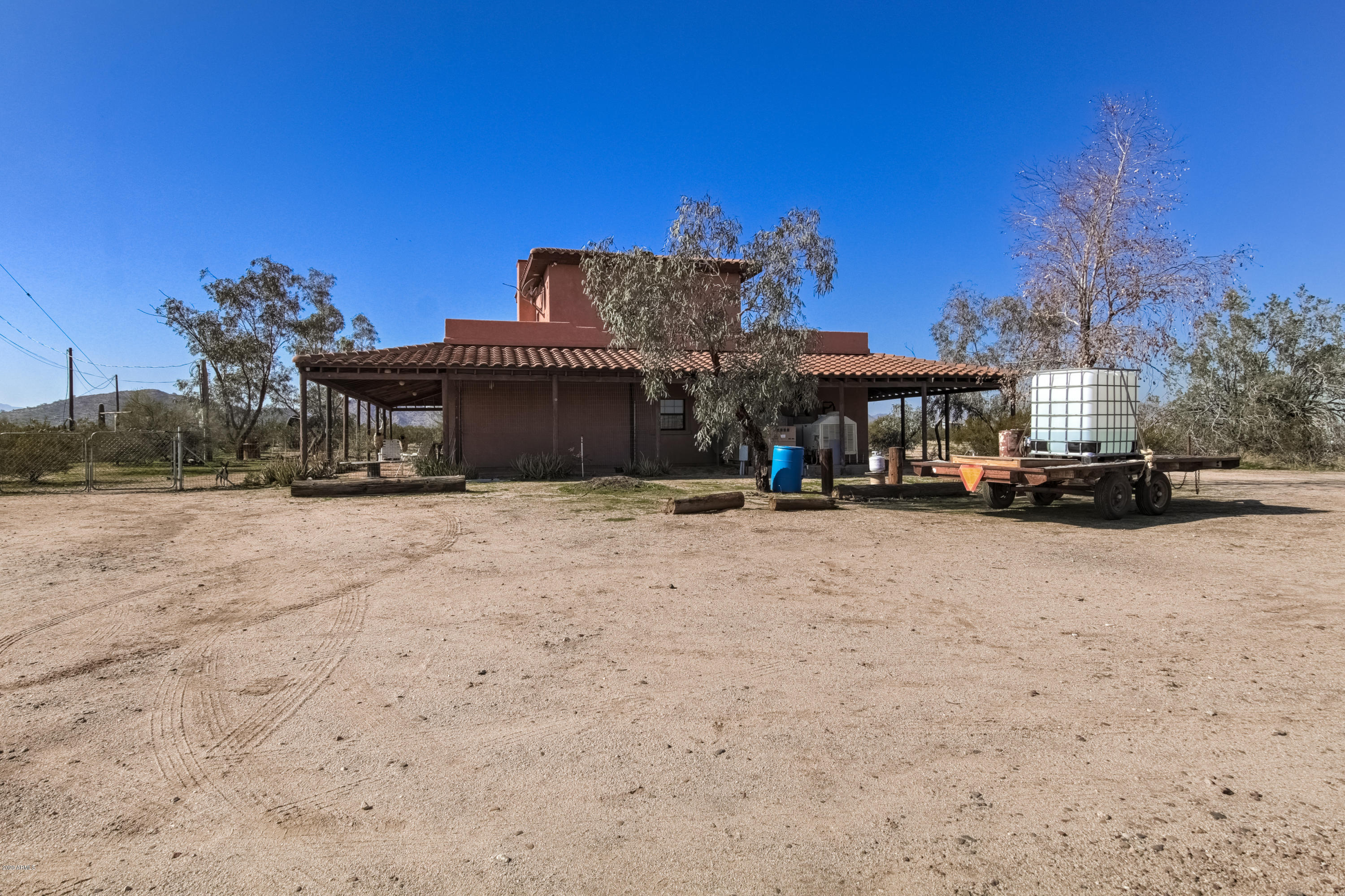 667 South Opal Road Maricopa, AZ 85139 - Photo 8 of 42 a view of a house with a big yard and large trees