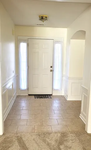 a view of empty room with wooden floor and cabinet