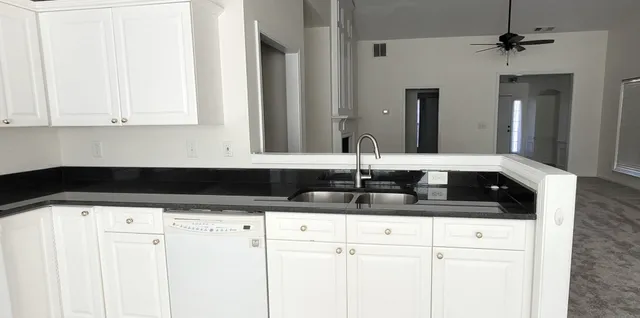 a kitchen with a sink and cabinets