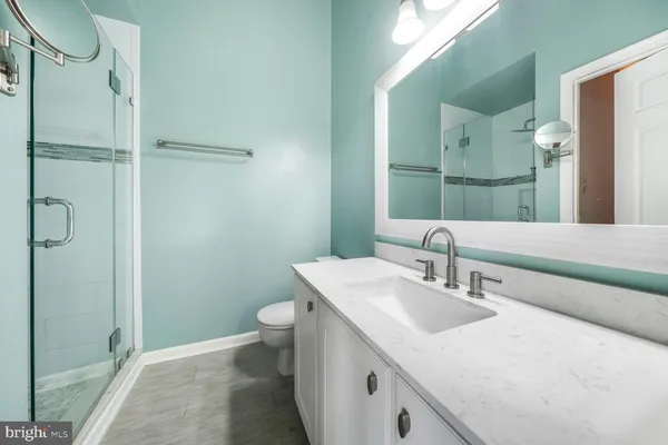 a bathroom with a sink toilet and shower