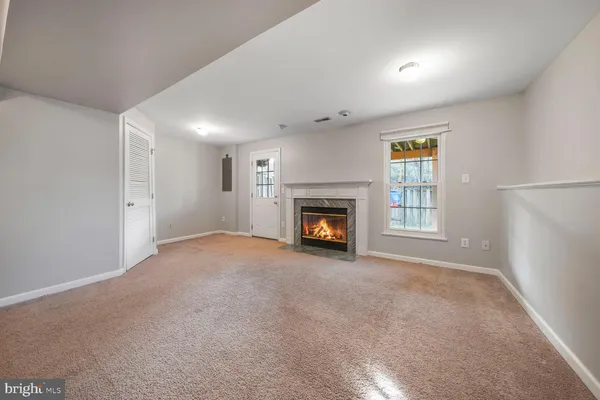a view of empty room with a fireplace
