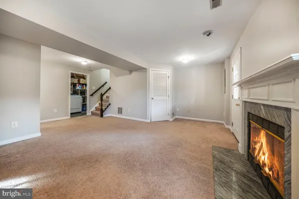 a view of empty room with a fireplace