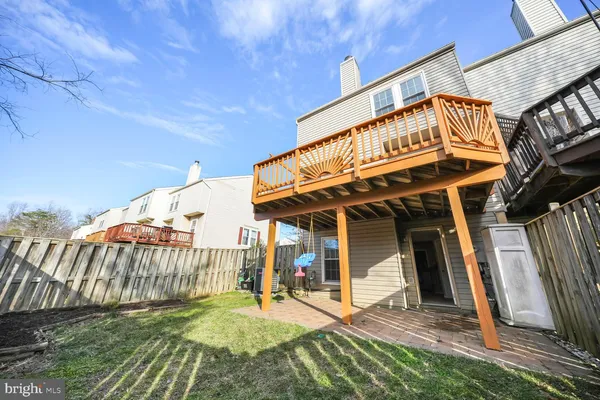 a view of a house with backyard and deck