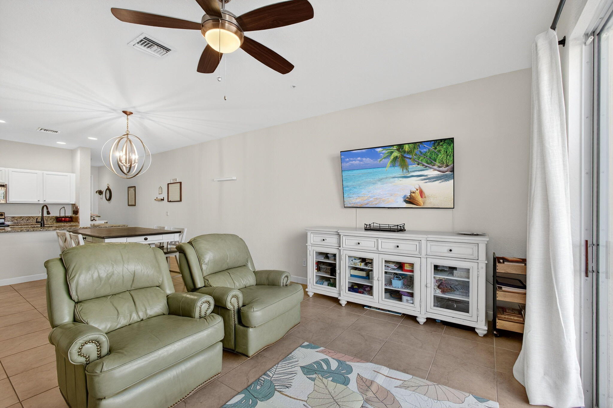 9440 Southwest Merlin Court Stuart, FL 34997 - Photo 18 of 54 a living room with furniture and a flat screen tv
