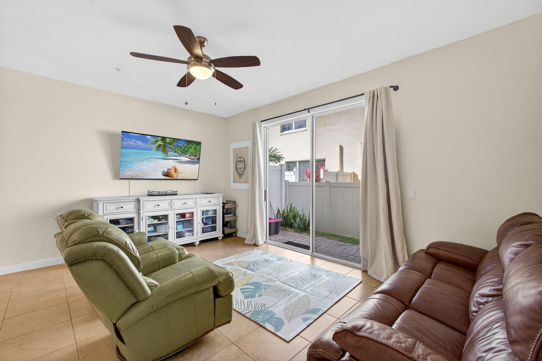 9440 Southwest Merlin Court Stuart, FL 34997 - Photo 19 of 54 a living room with furniture a ceiling fan and a rug