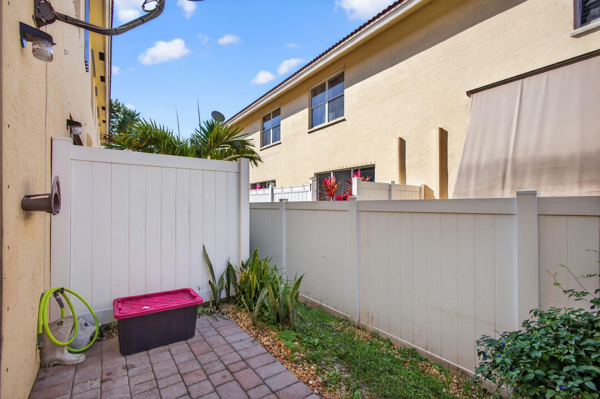 9440 Southwest Merlin Court Stuart, FL 34997 - Photo 21 of 54 a backyard of a house with potted plants and seating space