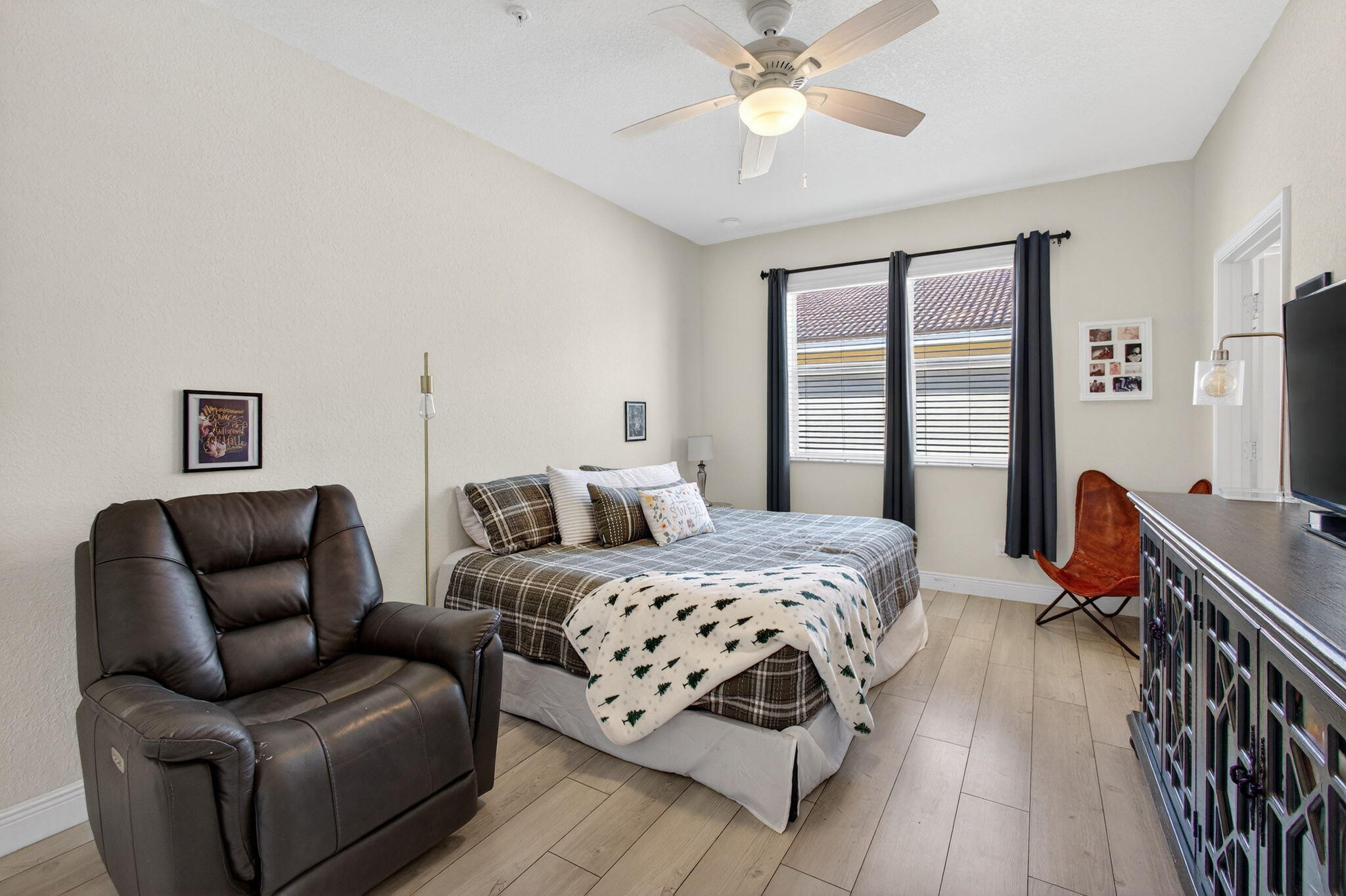 9440 Southwest Merlin Court Stuart, FL 34997 - Photo 24 of 54 a bedroom with furniture and a large window