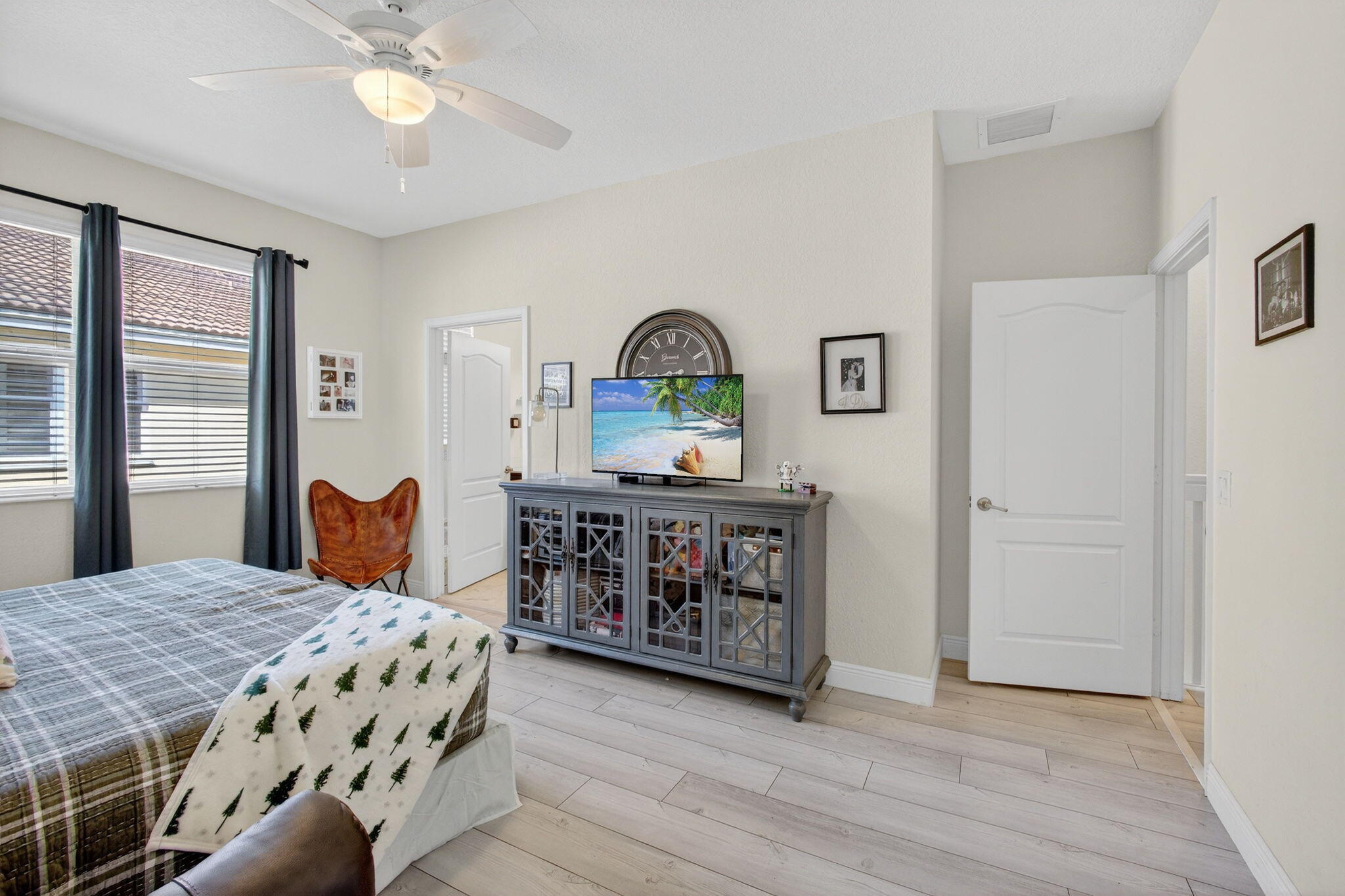 9440 Southwest Merlin Court Stuart, FL 34997 - Photo 25 of 54 a bedroom with a bed and a dresser