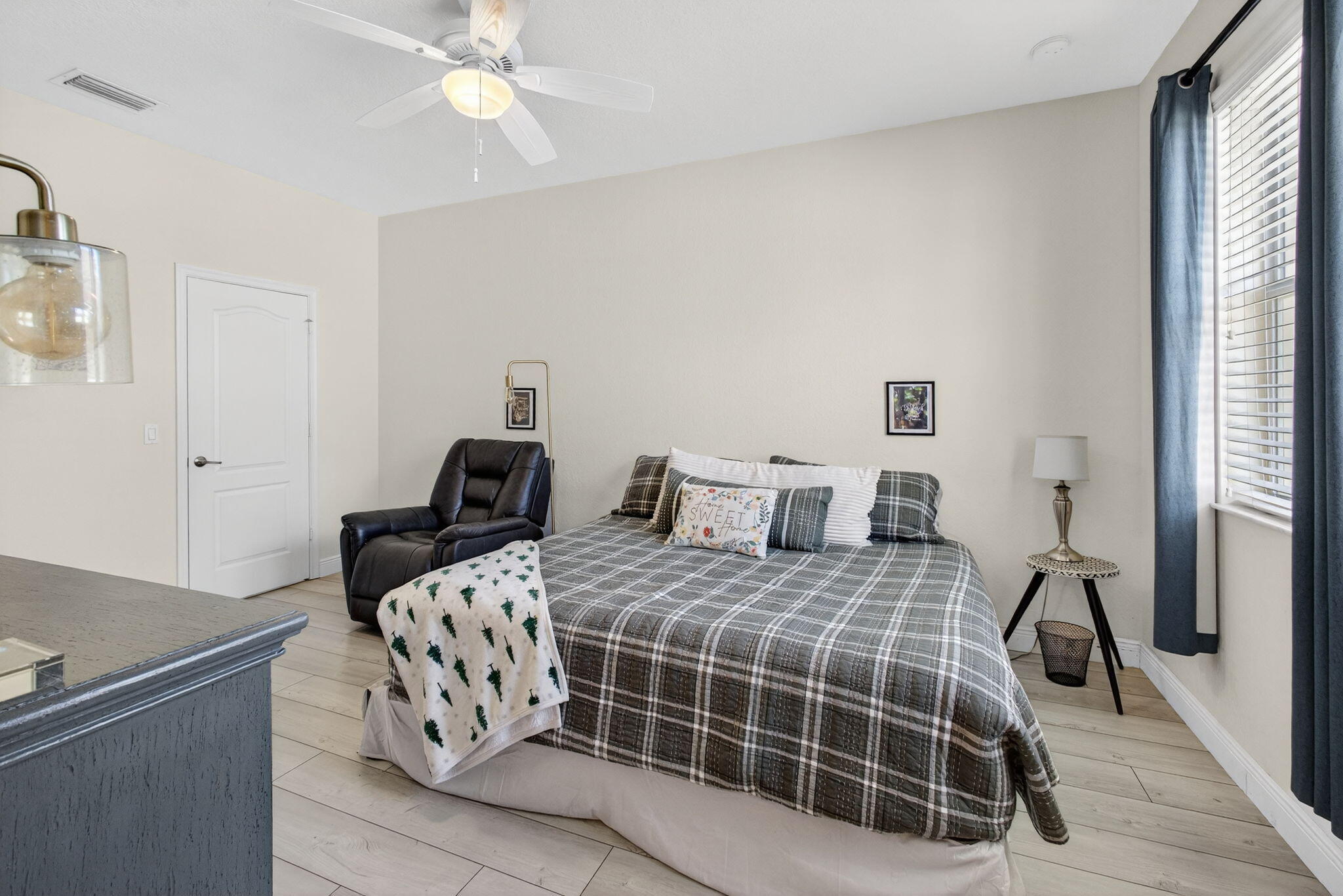 9440 Southwest Merlin Court Stuart, FL 34997 - Photo 26 of 54 a bedroom with a bed and a chandelier