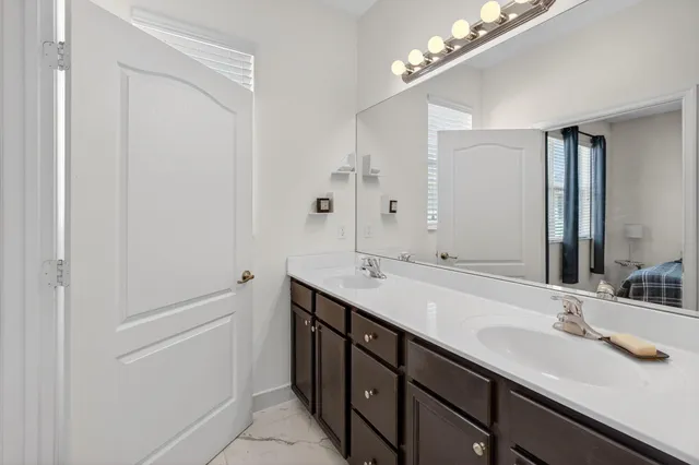 a bedroom with a bed furniture and a book shelf