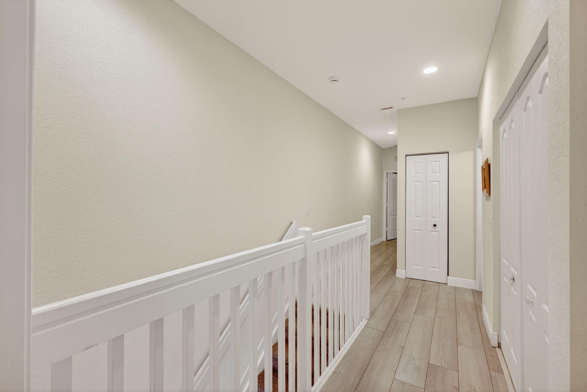 9440 Southwest Merlin Court Stuart, FL 34997 - Photo 32 of 54 a view of a hallway with wooden floor