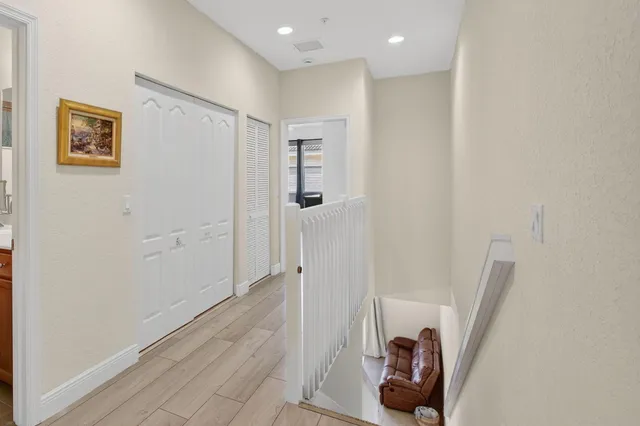 a living room with furniture and a bookshelf