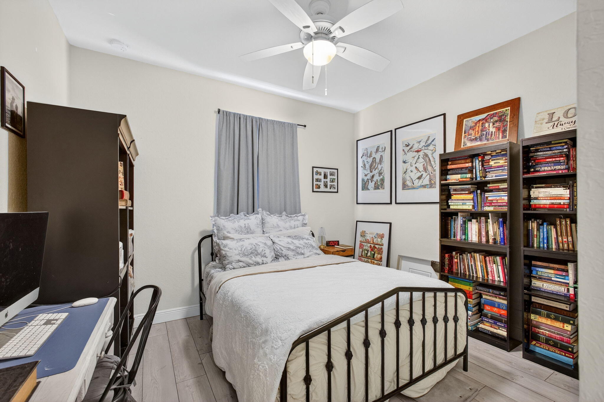 9440 Southwest Merlin Court Stuart, FL 34997 - Photo 35 of 54 a bedroom with a bed furniture and a book shelf