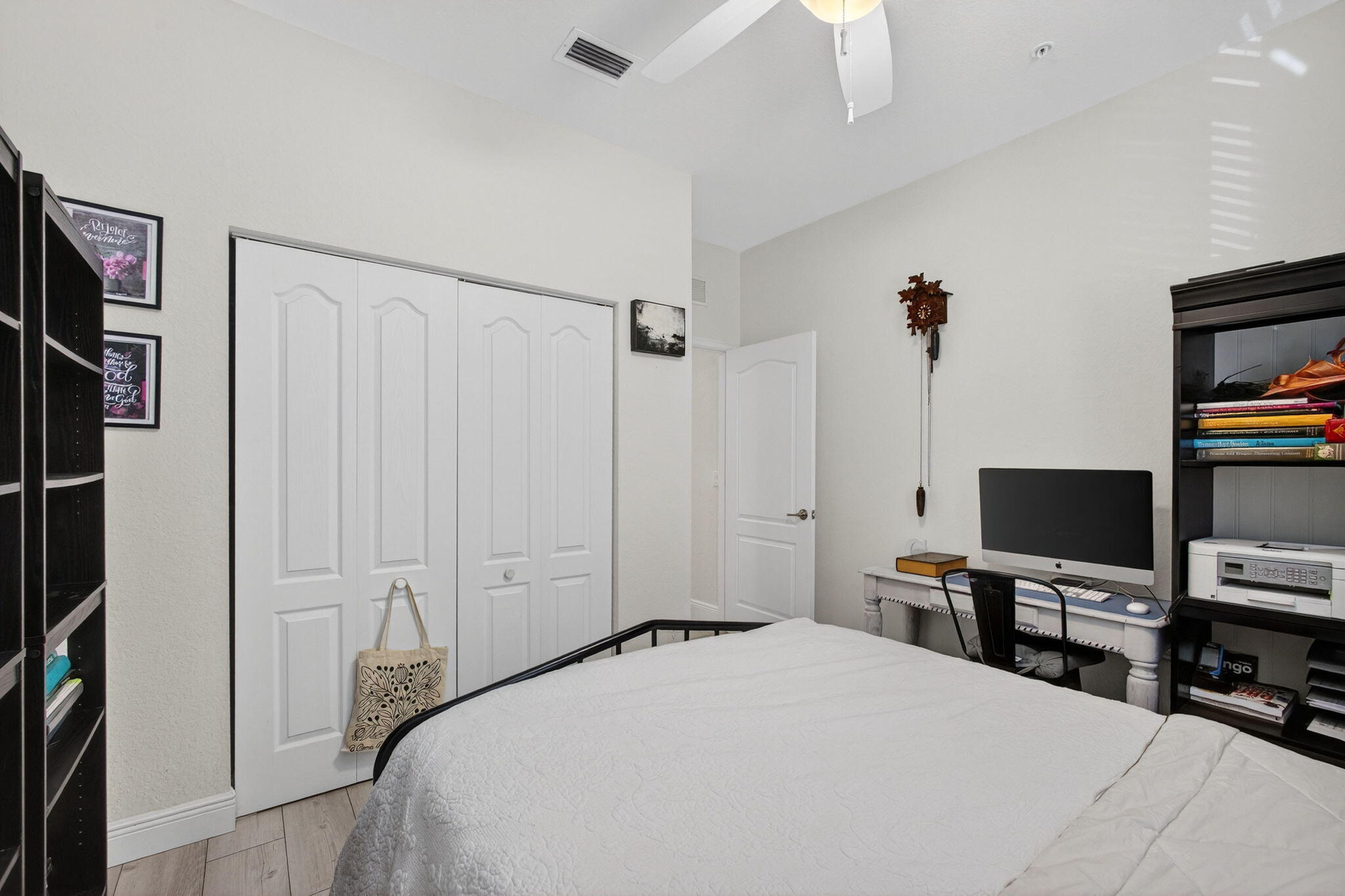 9440 Southwest Merlin Court Stuart, FL 34997 - Photo 36 of 54 a bedroom with a bed and a flat screen tv