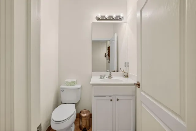 a bathroom with a toilet a sink and mirror
