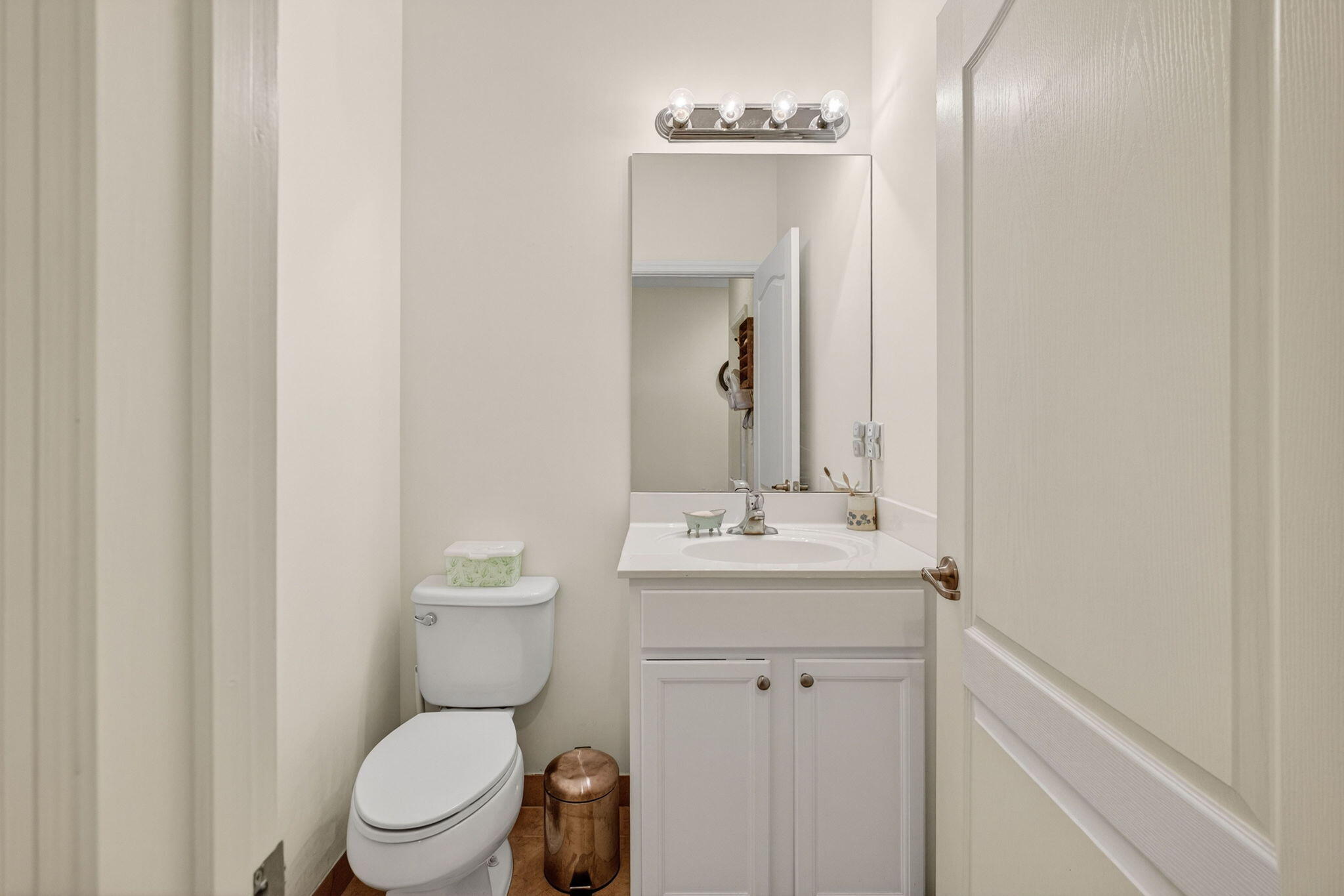 9440 Southwest Merlin Court Stuart, FL 34997 - Photo 4 of 54 a bathroom with a toilet a sink and mirror