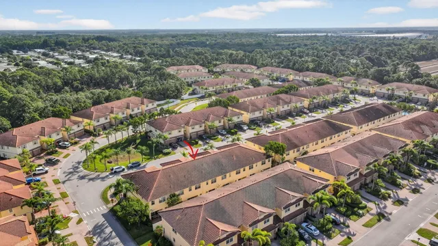 an aerial view of ocean and residential houses with outdoor space