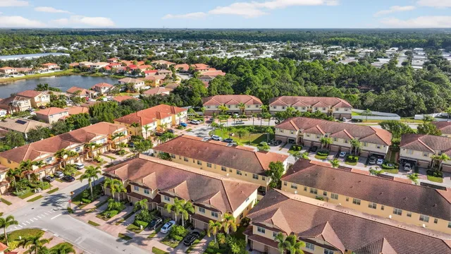 an aerial view of water body with boats and trees all around