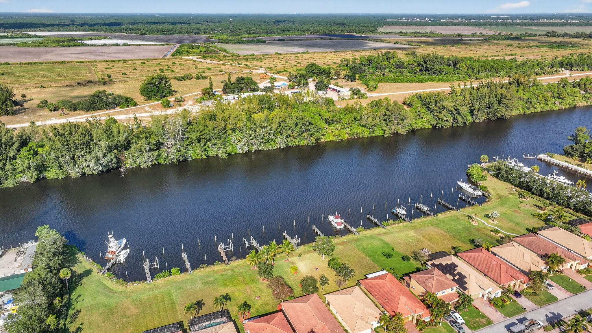 9440 Southwest Merlin Court Stuart, FL 34997 - Photo 50 of 54 an aerial view of water body with boats and trees all around