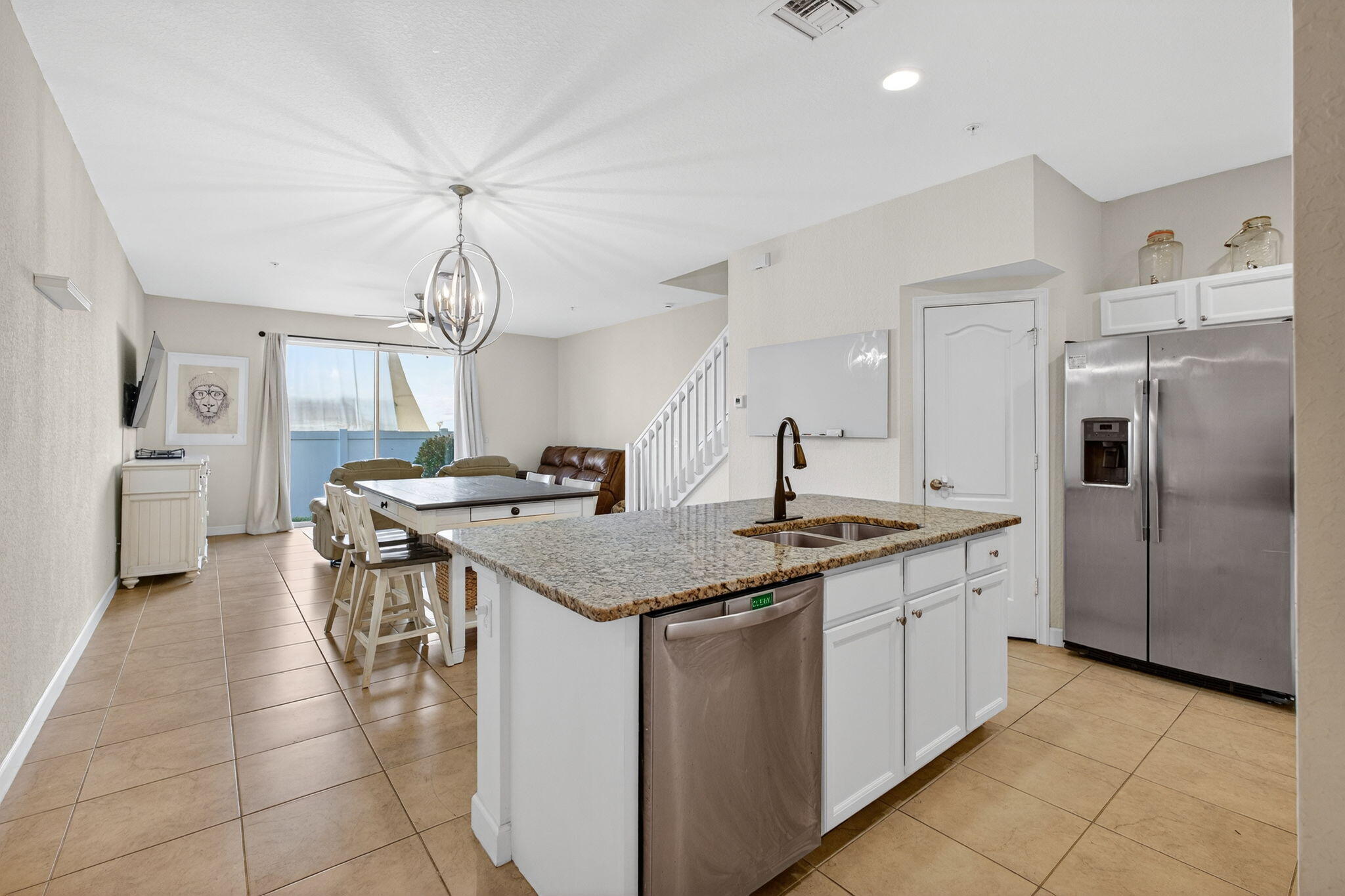 9440 Southwest Merlin Court Stuart, FL 34997 - Photo 7 of 54 a kitchen with stainless steel appliances granite countertop a sink and a refrigerator