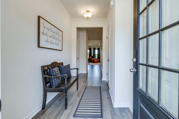 a view of a hallway with wooden floor and workspace