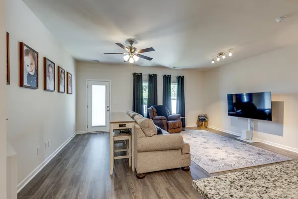 a living room with furniture and a flat screen tv