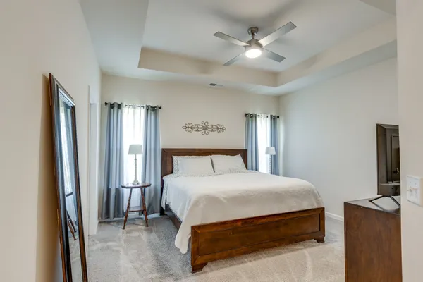 a bedroom with a bed dresser and a window