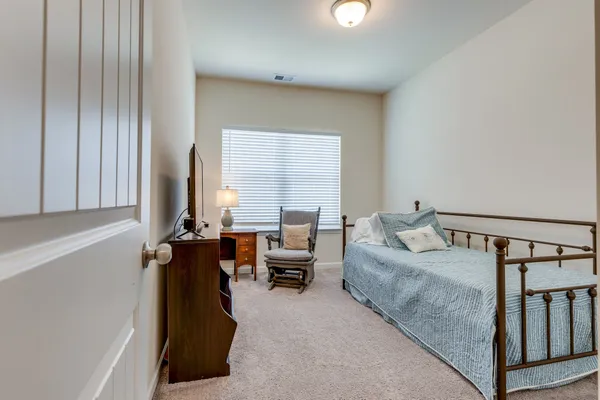a bedroom with furniture and a window