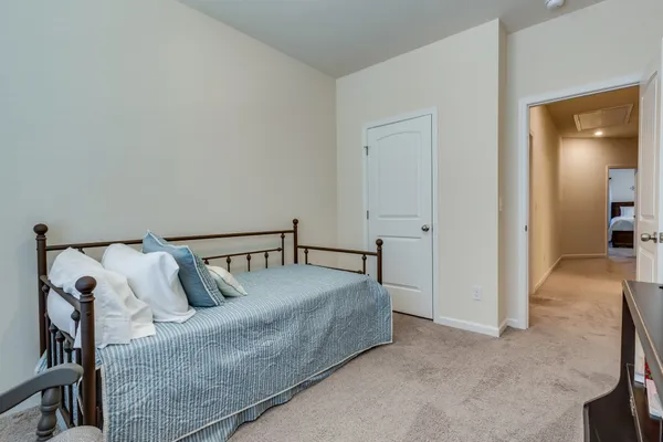 a bedroom with a bed and a lamp
