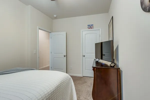 a bedroom with a bed and a flat screen tv