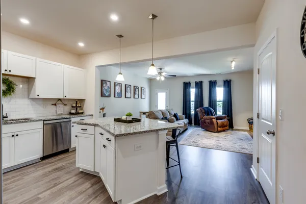 a view of a kitchen counter top space a sink stainless steel appliances and cabinets
