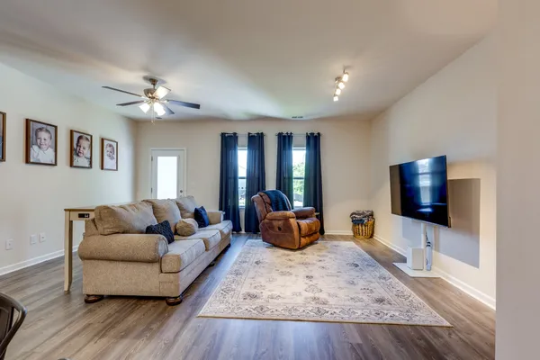 a living room with furniture and a flat screen tv