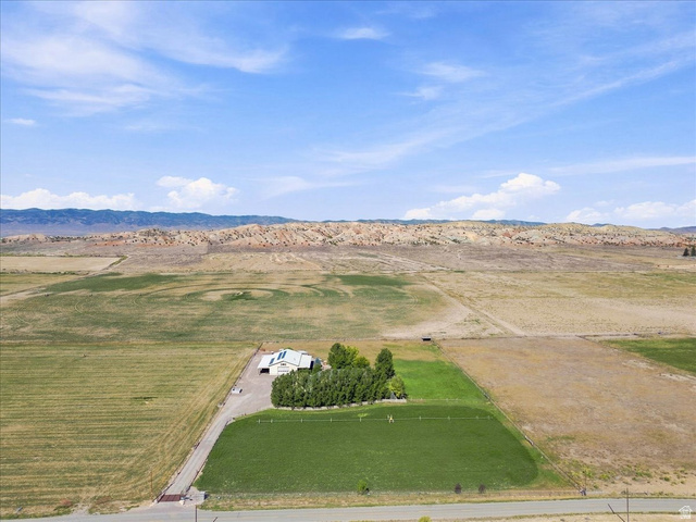11290 South Southfield Road Mayfield, UT 84643 - Photo 6 of 103 Single-story residence with a light-colored roof, attached garage, and surrounding green landscaping