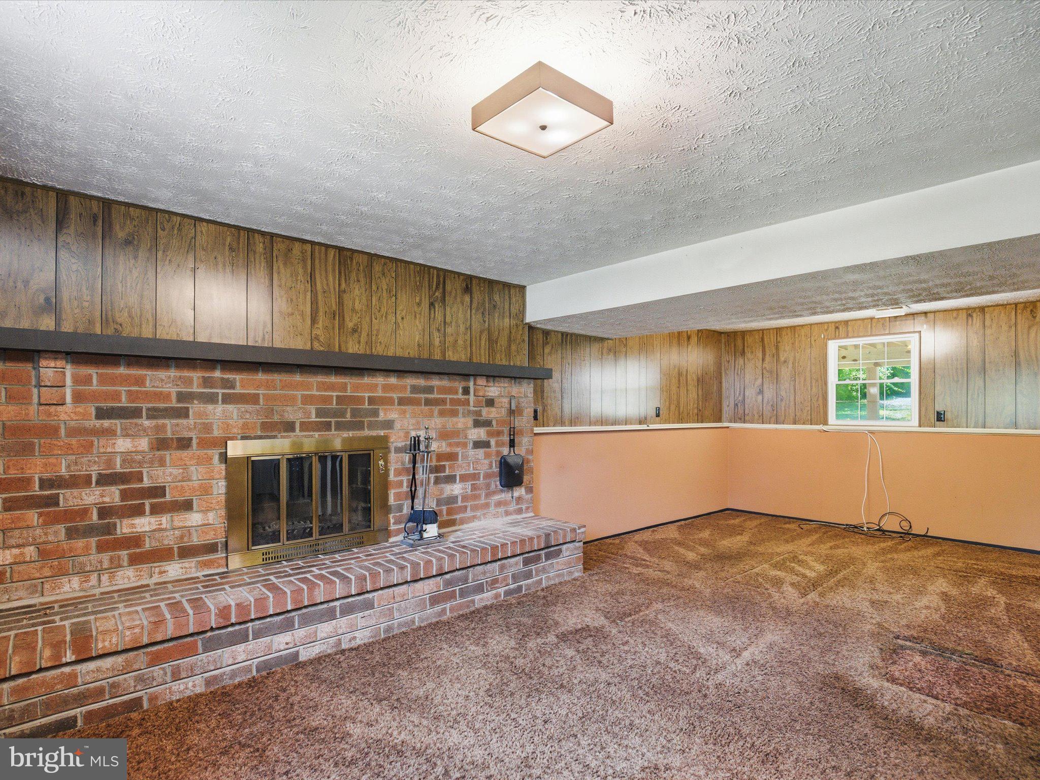 6314 West Vein Road Bowie, MD 20720 - Photo 25 of 28 a view of an empty room with wooden floor and a fireplace