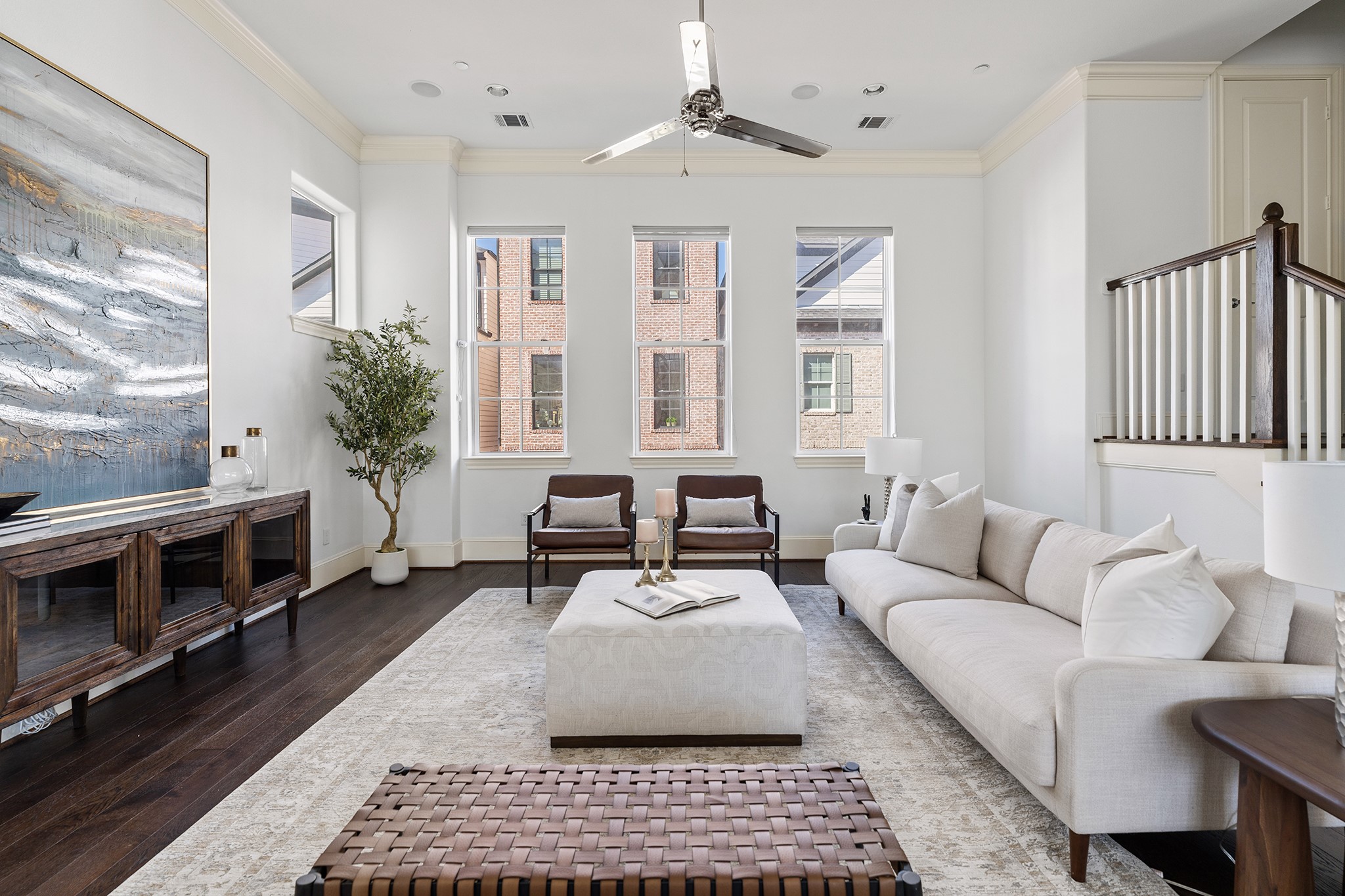 1314 Hunters Meadow Lane Houston, TX 77055 - Photo 7 of 37 The living room boasts dark hardwood floors and a contemporary ceiling fan creating a sophisticated and inviting atmosphere.