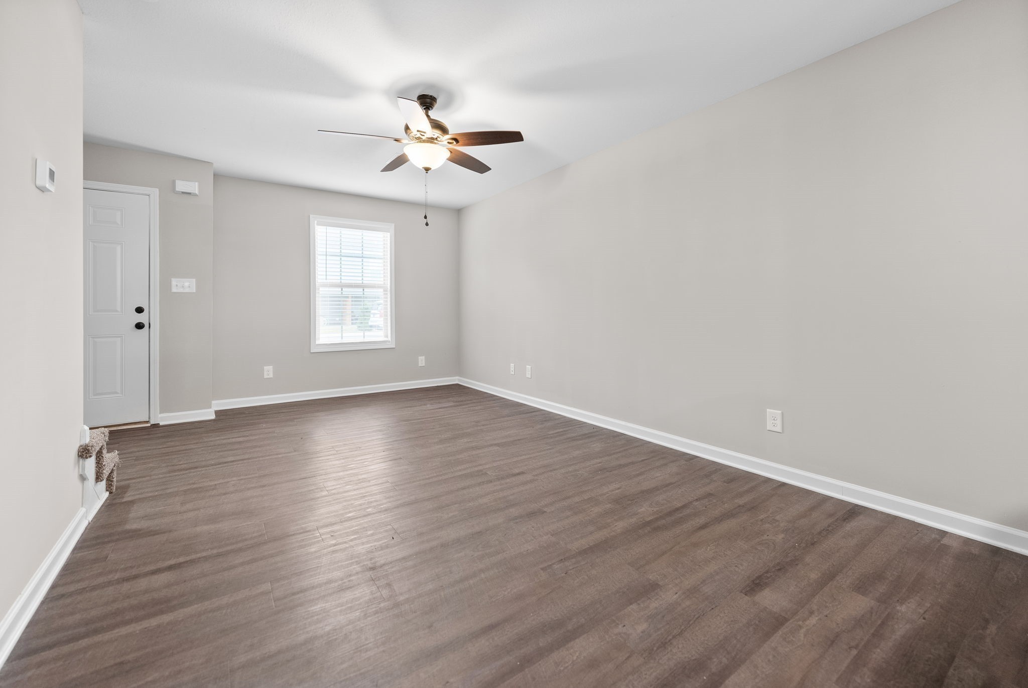 418 Peachers Mill Road, Unit G9 Clarksville, TN 37042 - Photo 5 of 21 a view of an empty room with wooden floor and a window